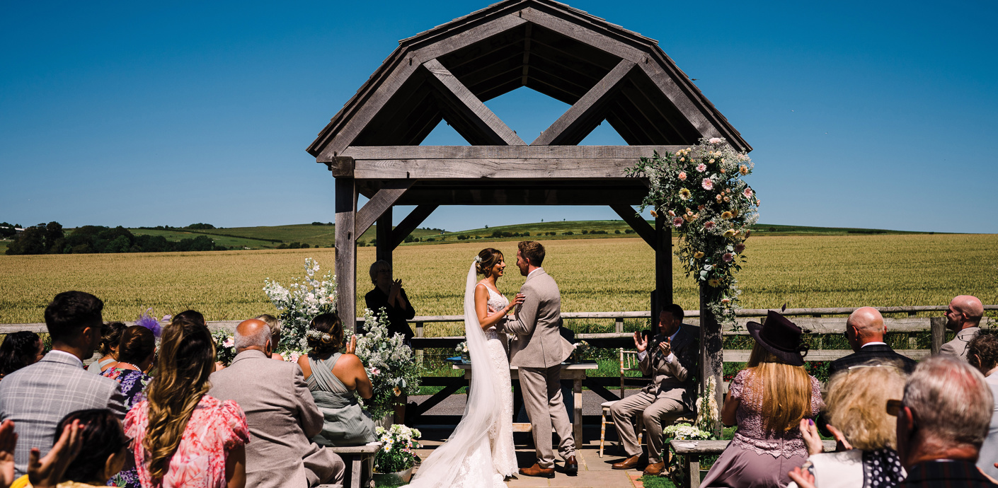 nojs Couple getting married in an outdoor ceremony.