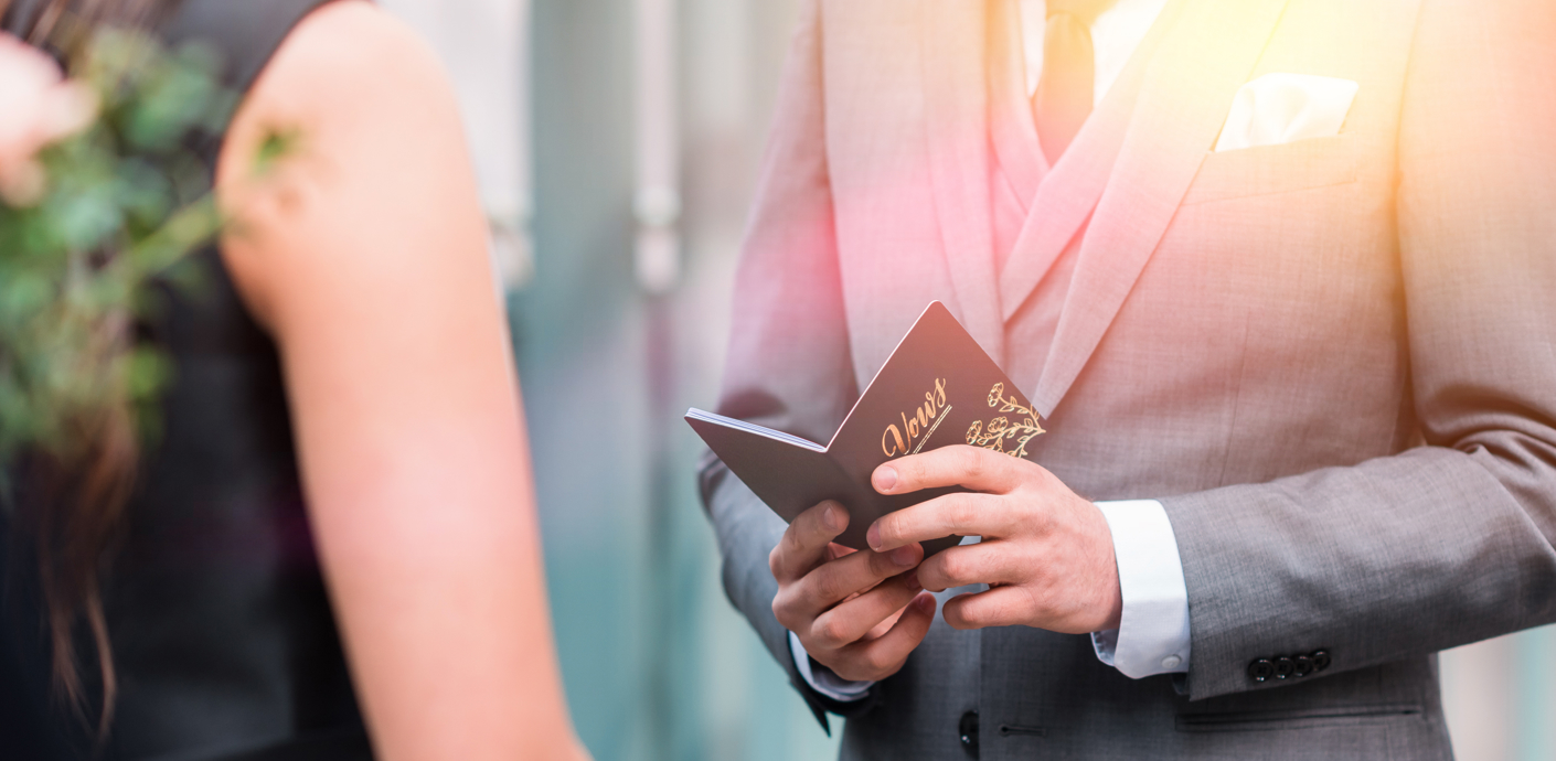 nojs Man reading vows to woman.