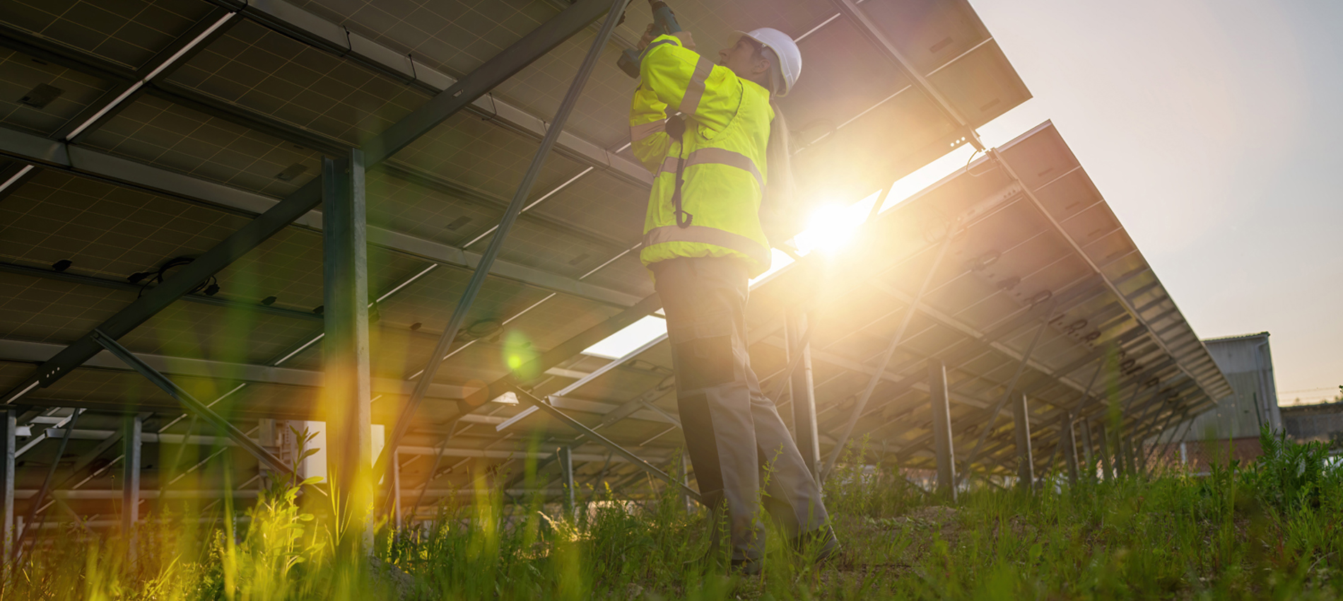 nojs Man installing solar panels in a field