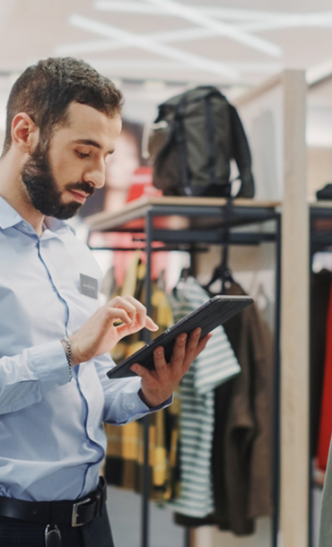 Man using an ipad in a clothes shop