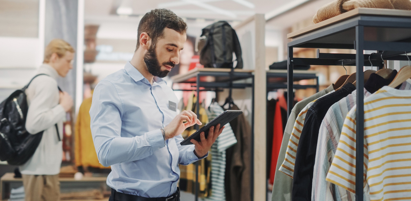 nojs Man using an ipad in a clothes shop