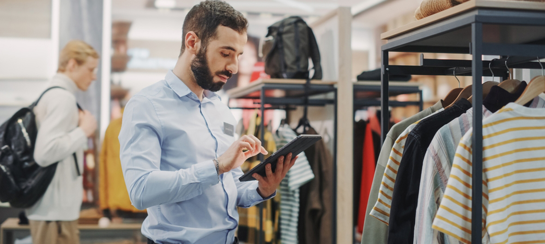 nojs Man using an ipad in a clothes shop