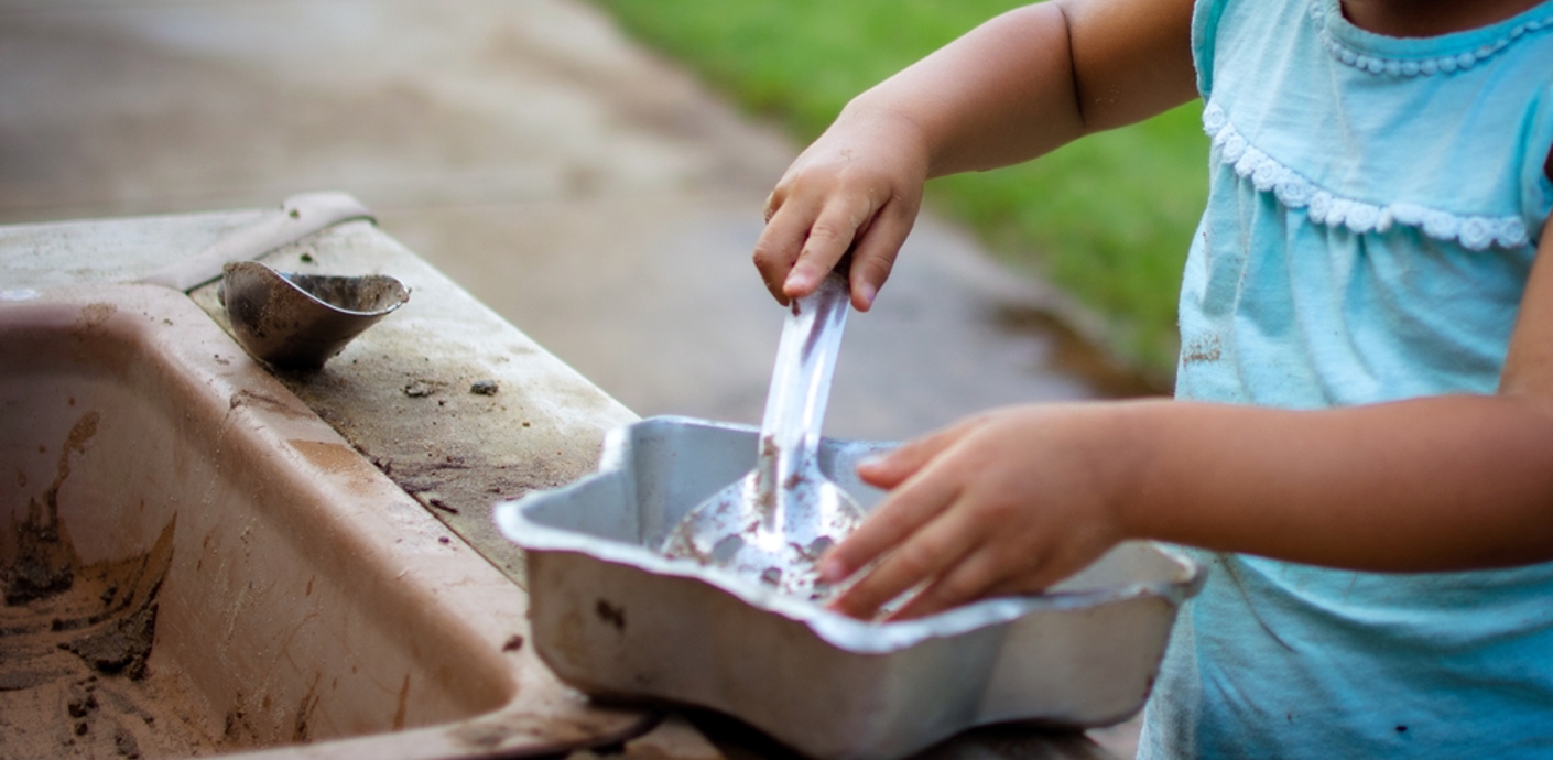 Child playing in a mud kitchen