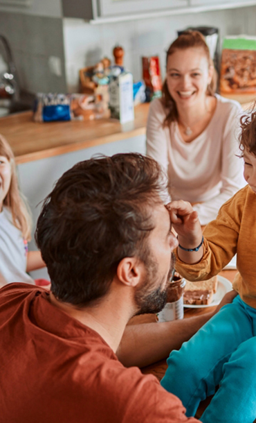 Family laughing in a kitchen