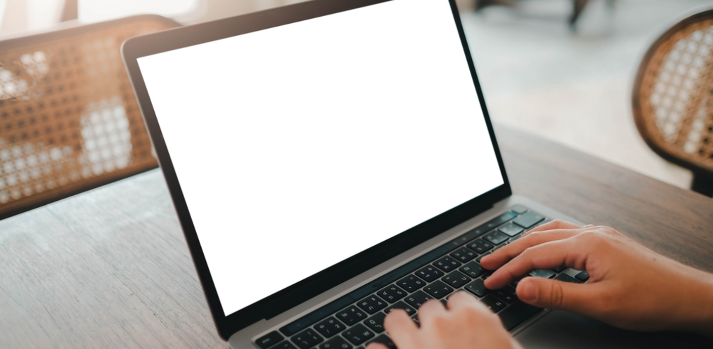 Person typing at a laptop screen