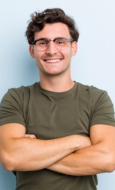 Man smiling with arms crossed